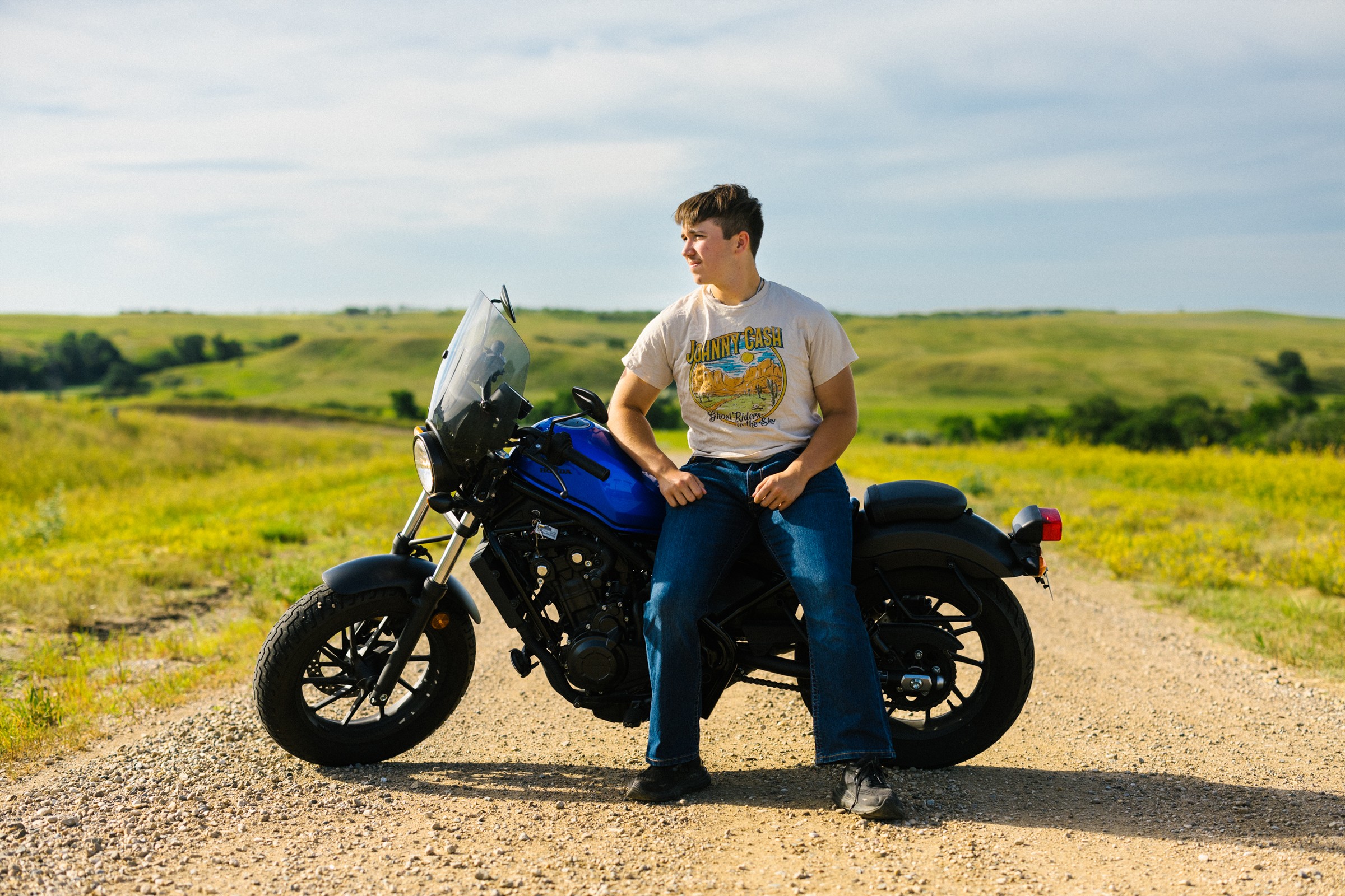 Young man by motor cycle outdoors 